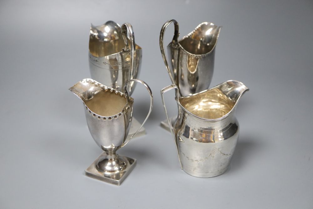 Four silver helmet-shaped cream jugs, approx 11oz